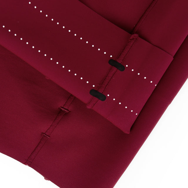 Close-up of a Ciele Athletics Women's FSTTight Short 7" in Crimson Red with white stitching details on a white background