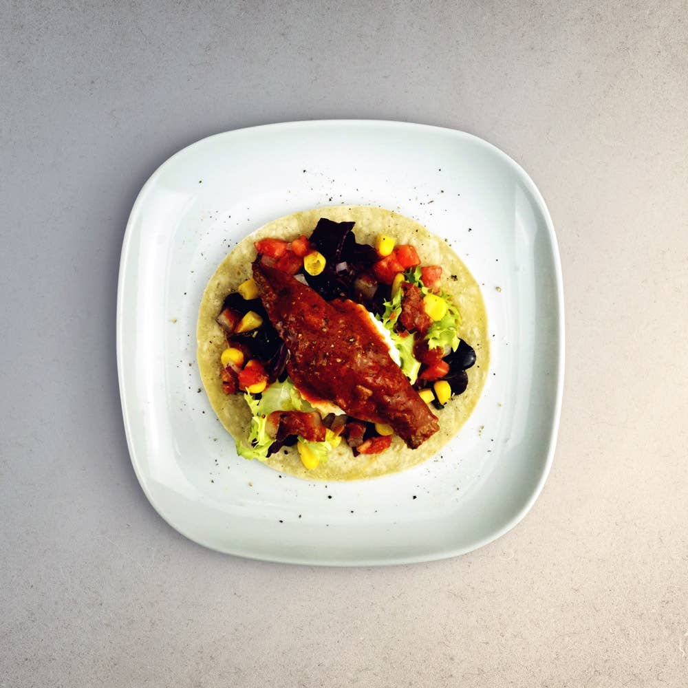 La Narval Mackerel Fillets in Tomato Sauce with vegetables on a white plate