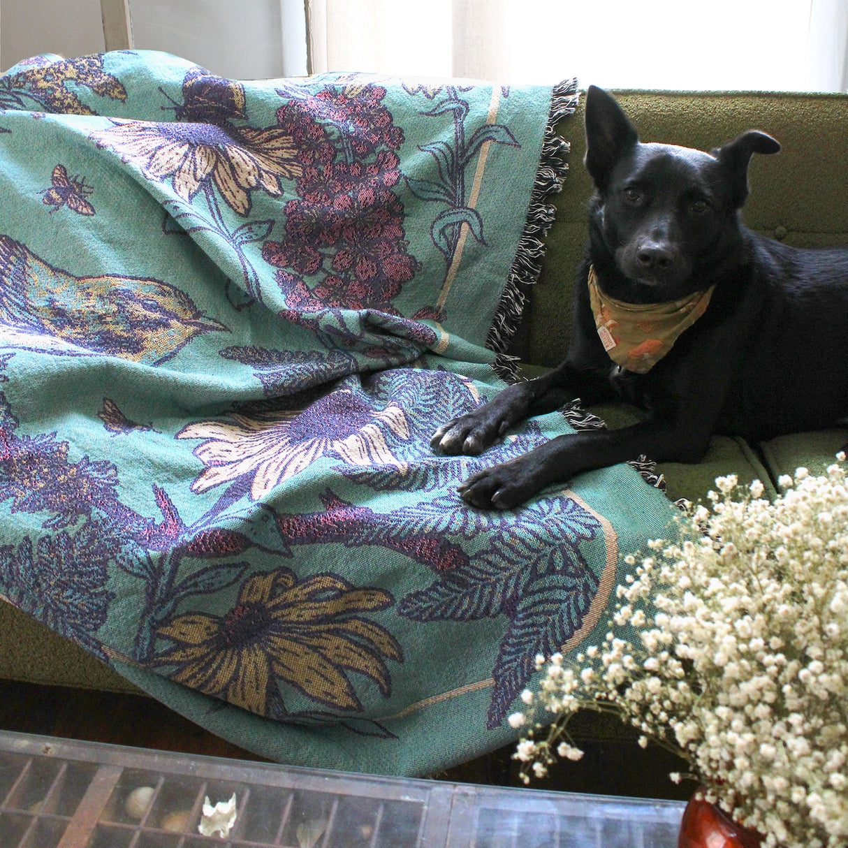 Mustard Beetle Prairie Woven Blanket Tapestry on a couch at home.