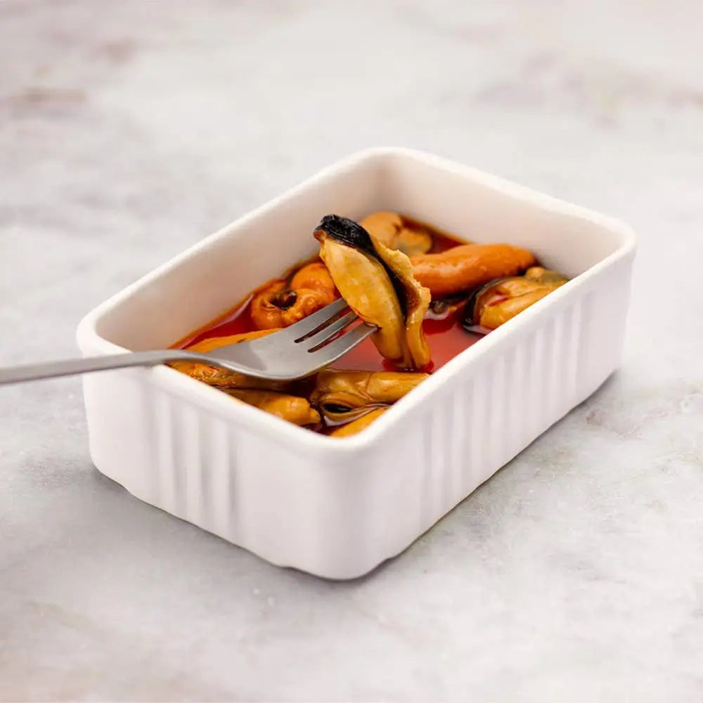 La Narval Ceramic Tin Holder holding mussels on a neutral background.