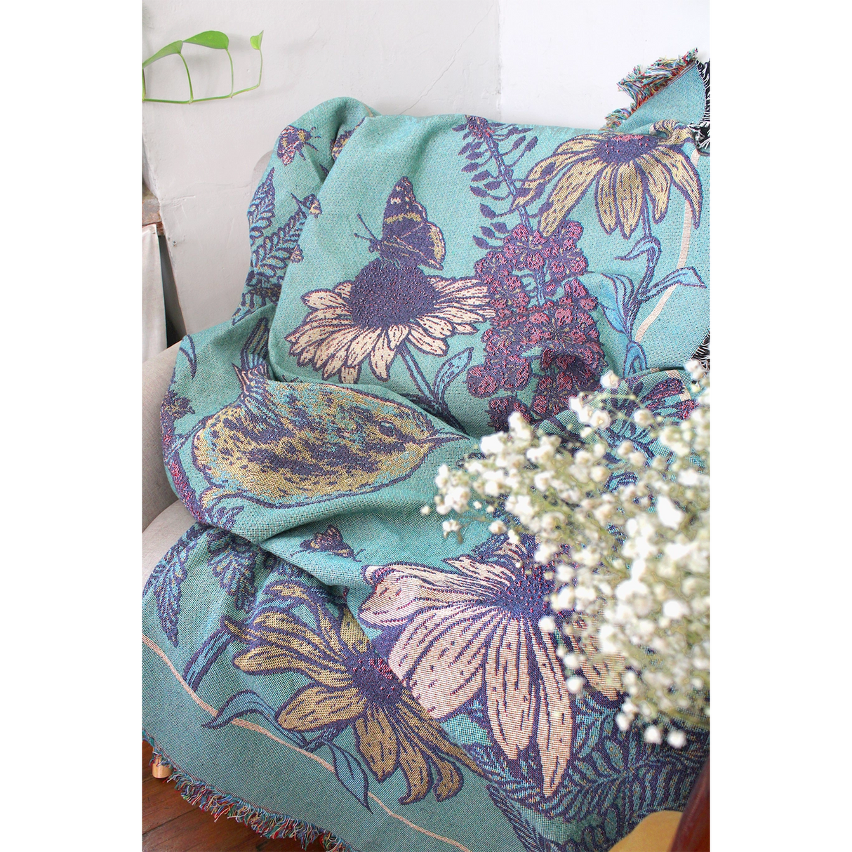 Mustard Beetle Prairie Woven Blanket Tapestry on a couch at home.