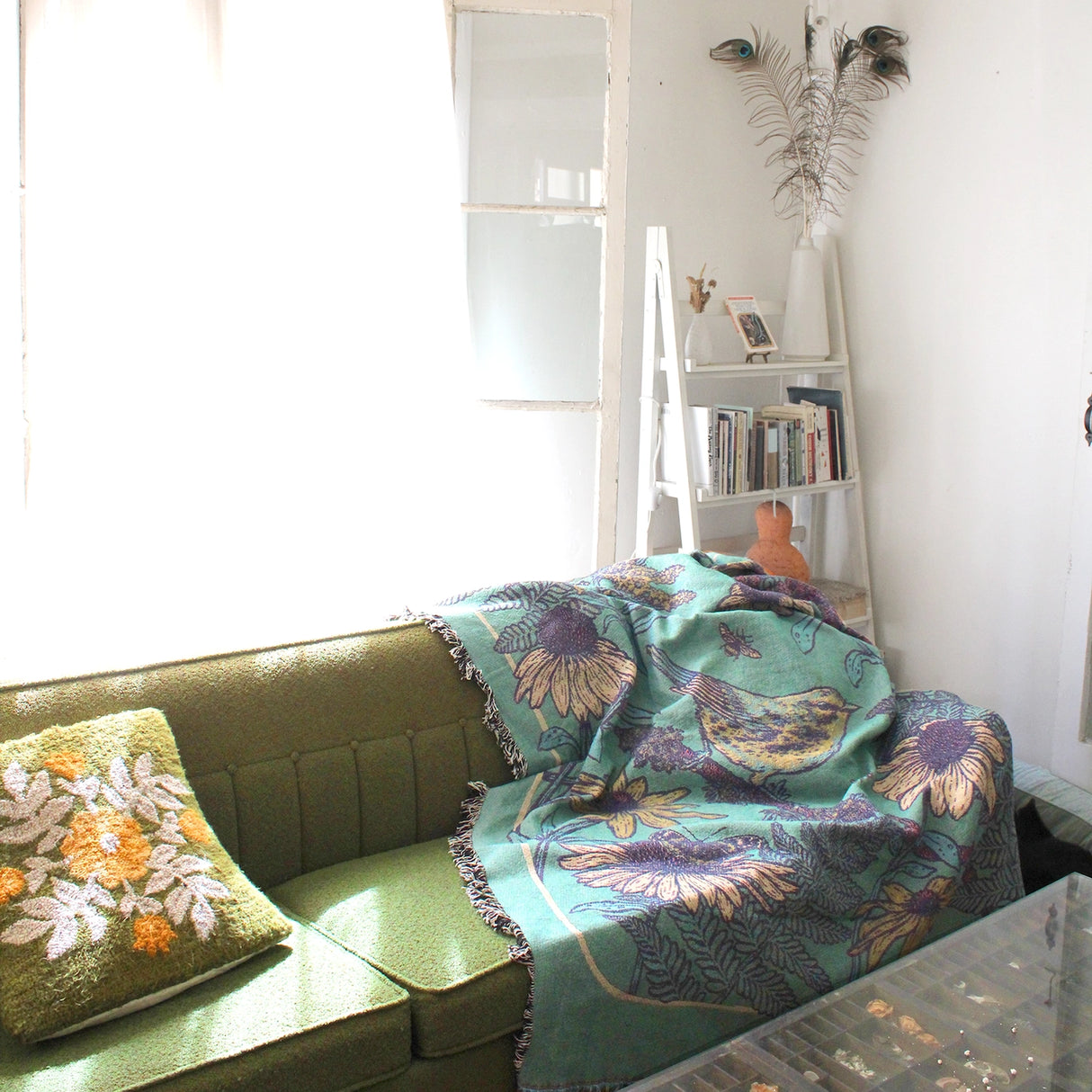 Mustard Beetle Prairie Woven Blanket Tapestry on a couch at home.