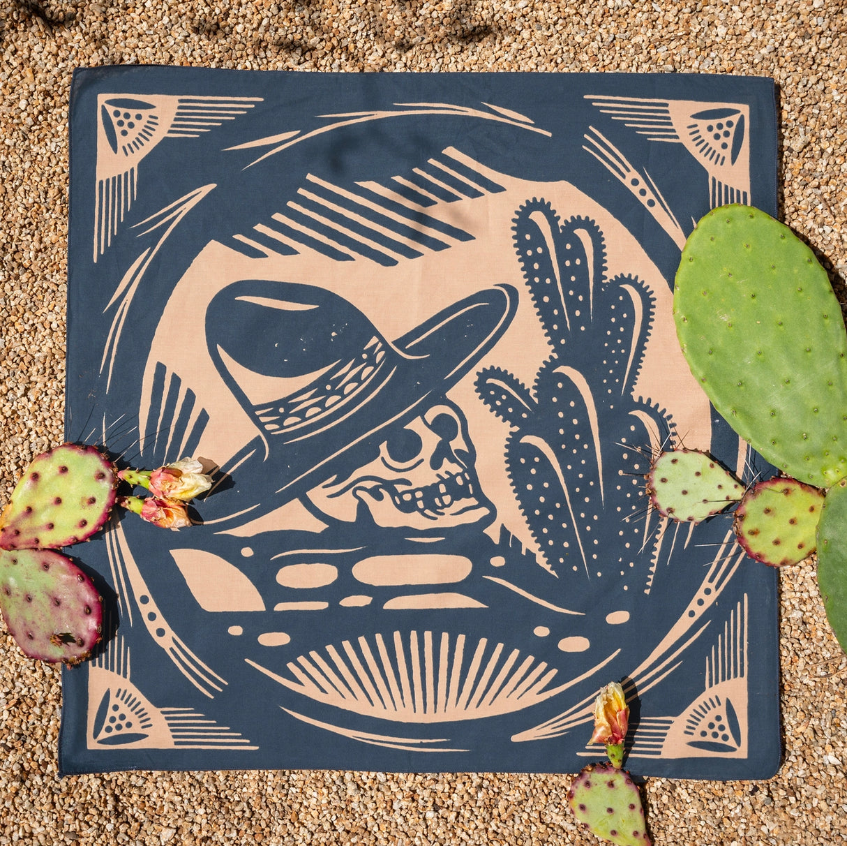 Bandits El Rito Nights Bandana with a skull wearing a cowboy hat and cactus design on a textured surface.