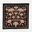 Land & She Field of Mushrooms Bandana on a neutral brick background.