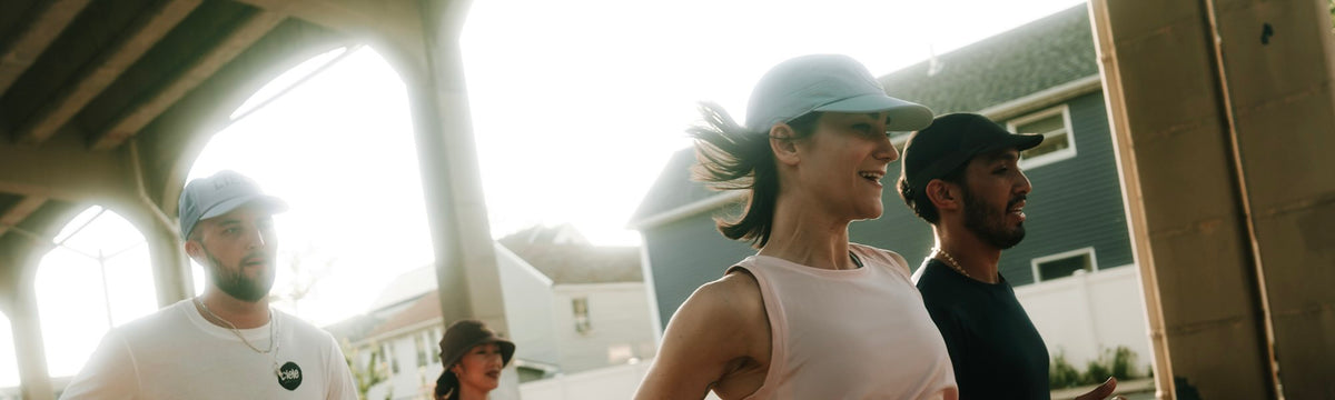 People running while wearing ciele athletics GOCaps.