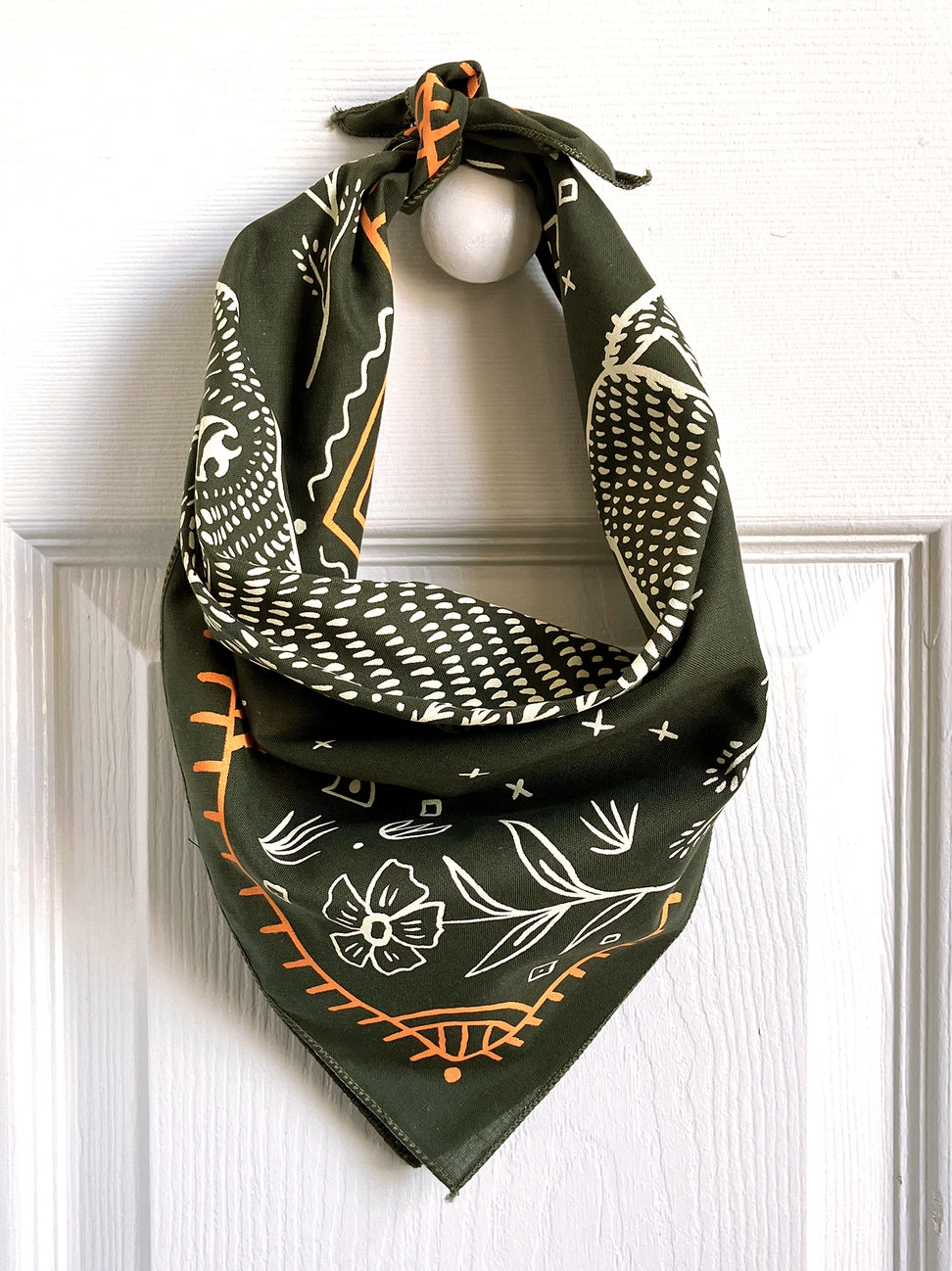 Land & She Pine Bear Bandana hung on a neutral background.