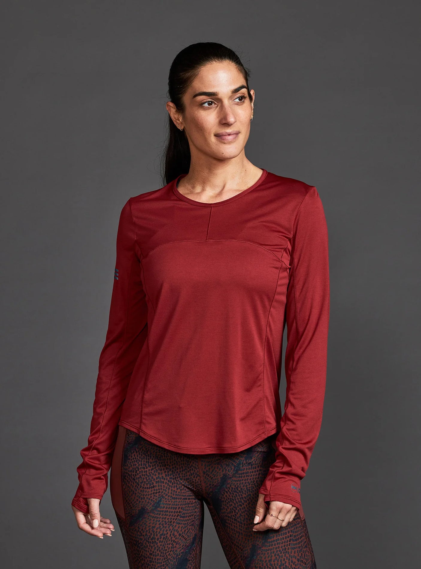Janji W's Run All Day Long Sleeve in Spice worn by a woman on a neutral background.