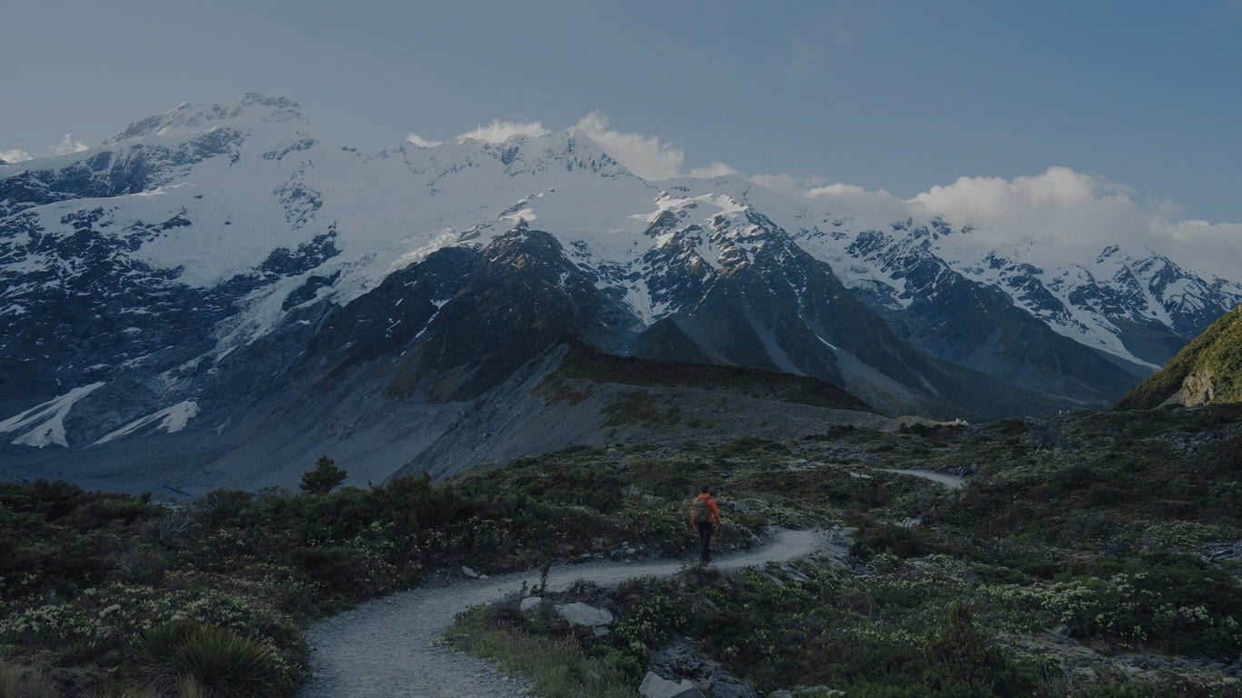 Hiker outdoors among a winter mountain scene.