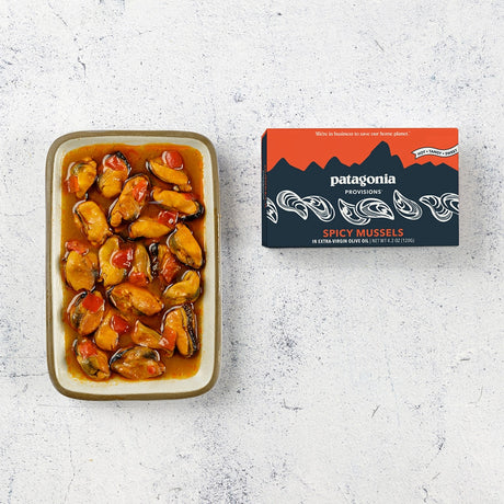 Patagonia Provisions Spicy Mussels tinned fish packaging and contents on a neutral background.