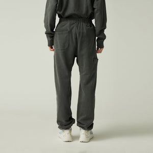 Person wearing Snow Peak Garment Dyed Pants in Charcoal and a matching top on a plain background