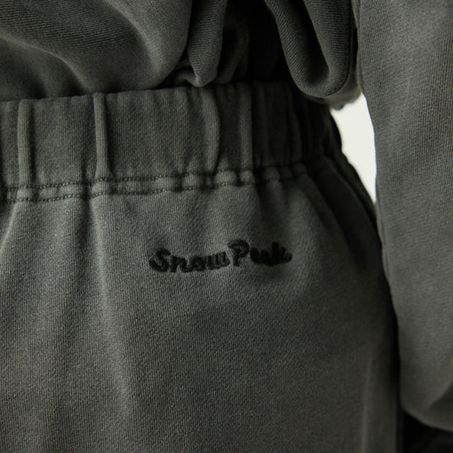 Close-up of a Snow Peak Garment Dyed Pants in Charcoal with 'Snow Peak' logo.