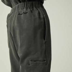 Snow Peak Garment Dyed Pants in Charcoal with a brand logo on a light beige background