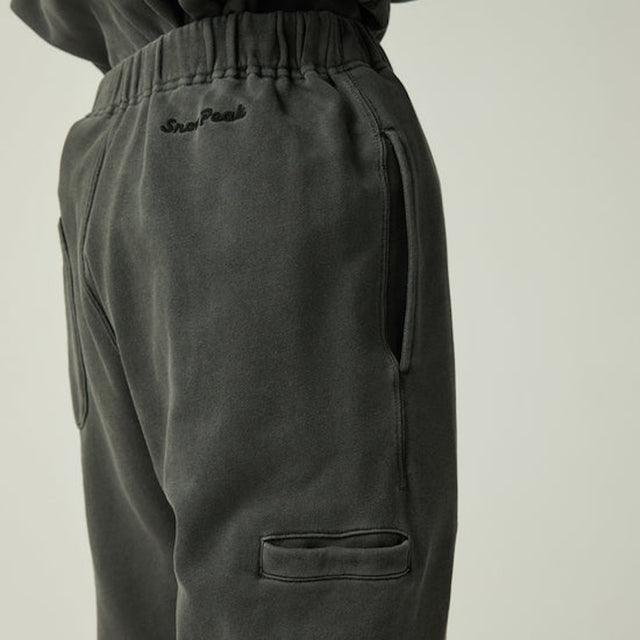 Snow Peak Garment Dyed Pants in Charcoal with a brand logo on a light beige background