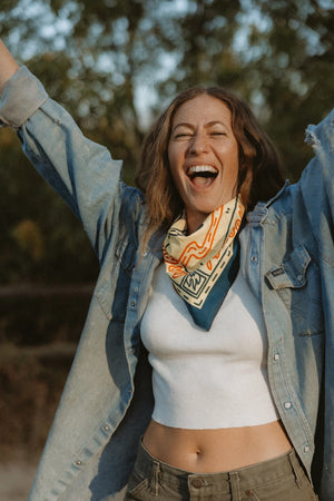 Bandits Grab The Horns bandana worn by a woman outdoors.