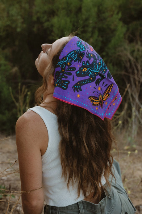 Bandits Electric Desert Parade bandana worn by a woman outdoors.