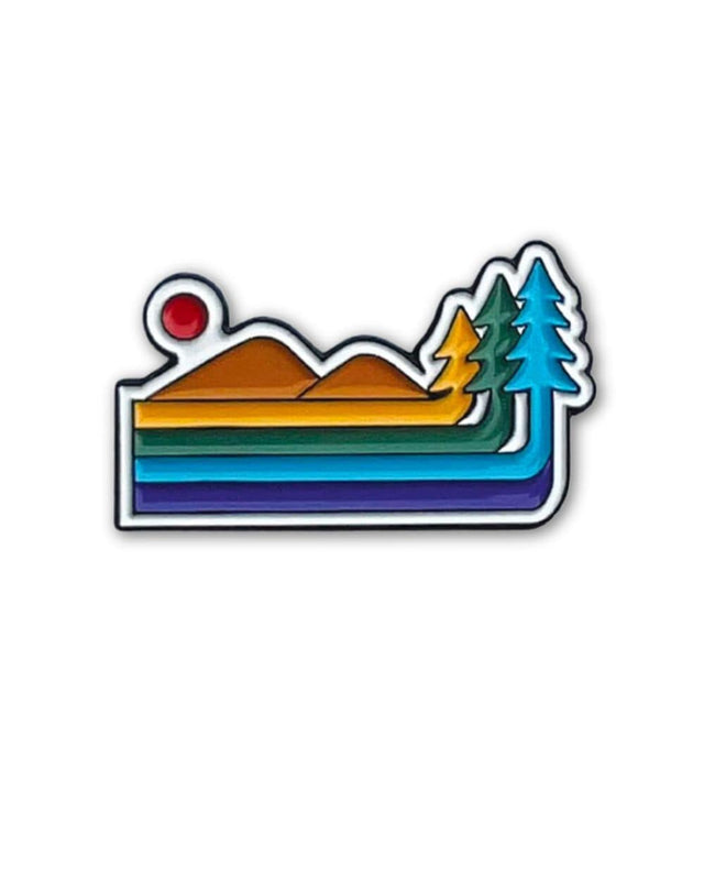 Keep Nature Wild Retro Pride pin features a mountain and forest design in the colors of the Pride flag.