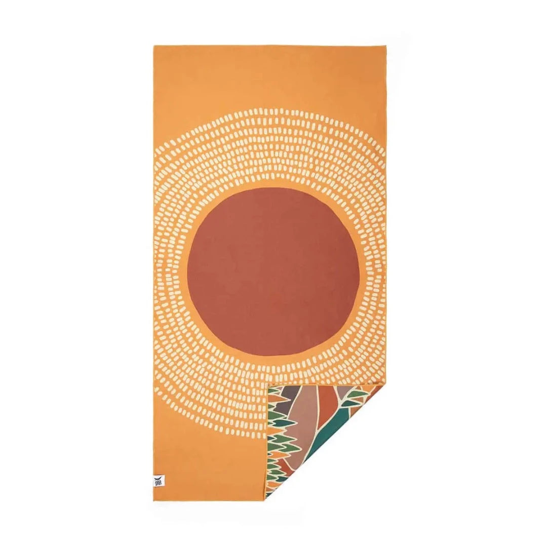 Trek Light Alpenglow Wander towel is made from recycled plastic bottles and features an abstract depiction of the mountains and sun.