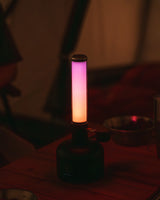Snow Peak GigaPower Tabletop Lantern being used while camping and showing the color change mode.