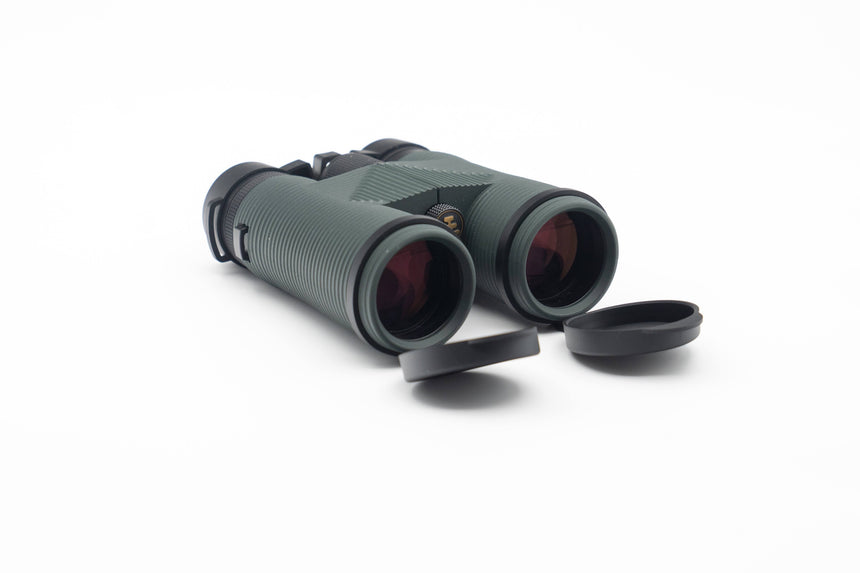 Nocs Provisions Pro Issue 8X Waterproof Binoculars in Alpine Green on a neutral background and showing the end caps.