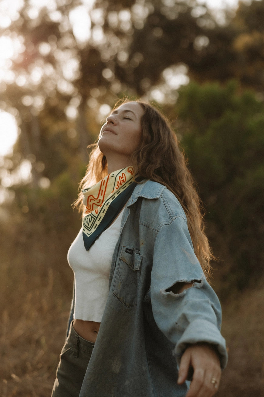 Bandits Grab The Horns bandana worn by a woman outdoors.