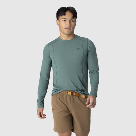 Man wearing an Outdoor Research Men's Echo Long Sleeve Tee in Malachite on a white background