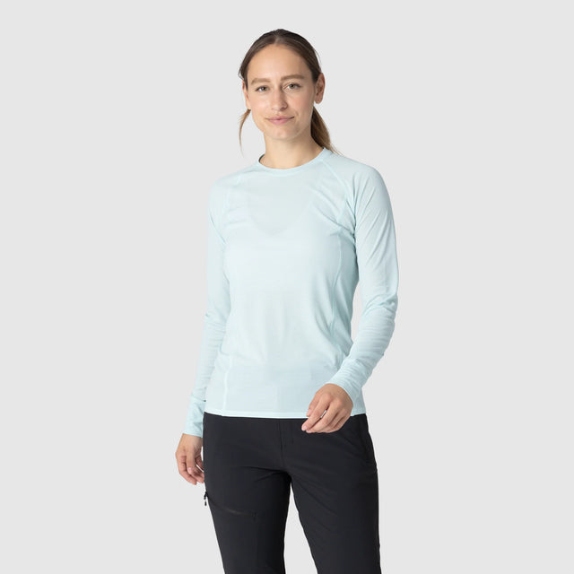 Woman wearing an Outdoor Research Women's Echo Long Sleeve Tee in Tidal on a white background