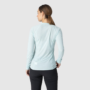 Person wearing an Outdoor Research Women's Echo Long Sleeve Tee in Tidal on a white background