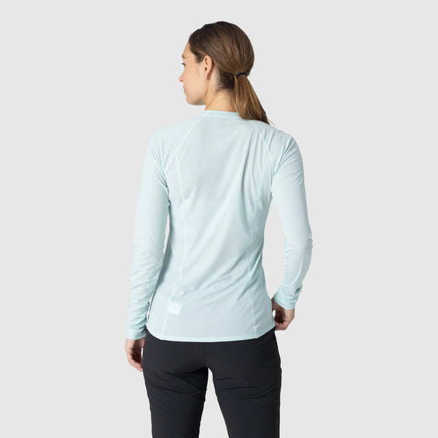 Person wearing an Outdoor Research Women's Echo Long Sleeve Tee in Tidal on a white background