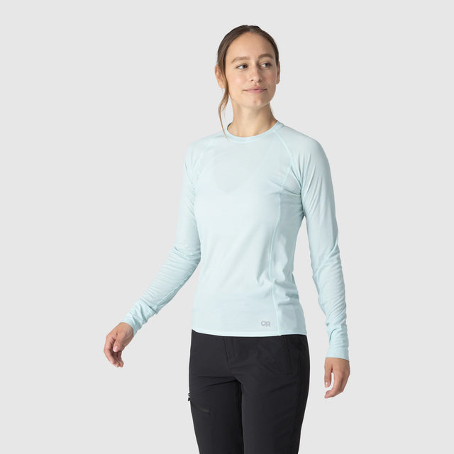 Woman wearing an Outdoor Research Women's Echo Long Sleeve Tee in Tidal on a white background