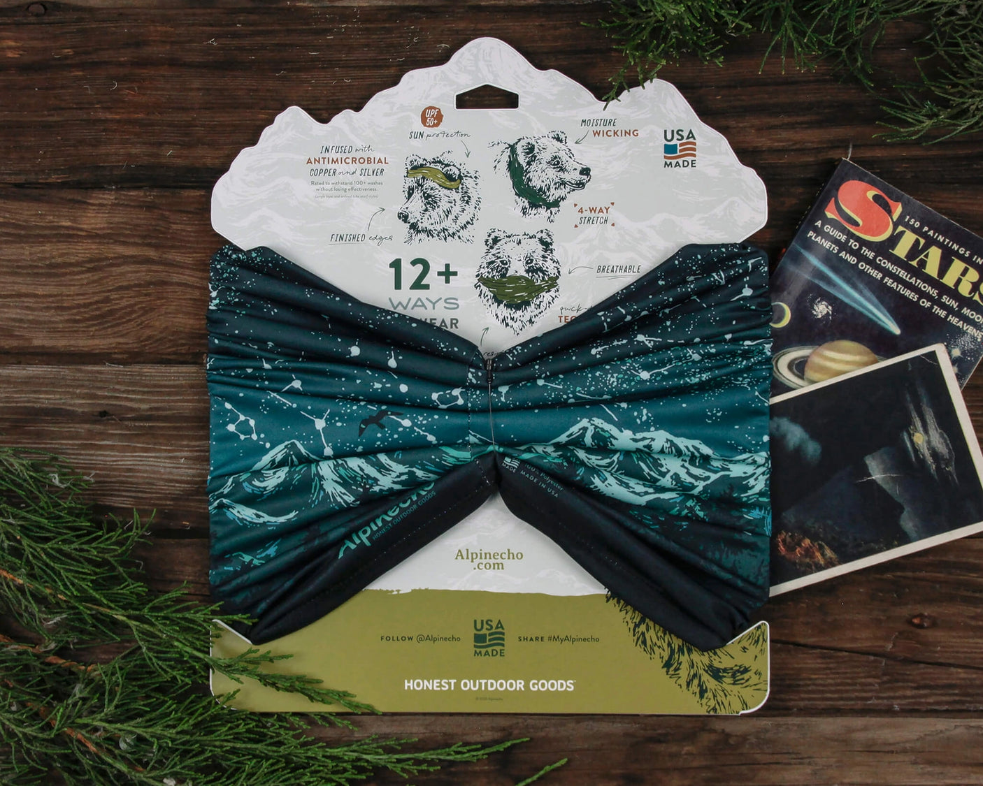 Alpinecho's Stargazer Neck Gaiter in Turquoise packaged on a dark wood background.