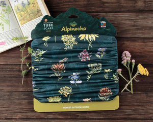 Alpinecho's Wildflowers Neck Gaiter on a dark wood background.