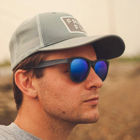 Cape Clasp Tikos recycled plastic sunglasses in a black frame with blue polarized lenses.