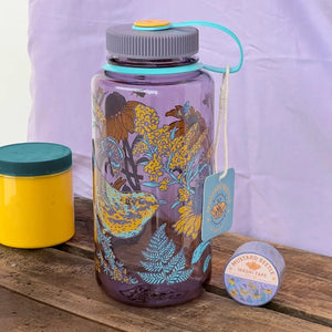 Mustard Beetle 32oz Nalgene bottle with the Prairie Warbler design, featuring a bird and flowers on a lavender colored Nalgene bottle.