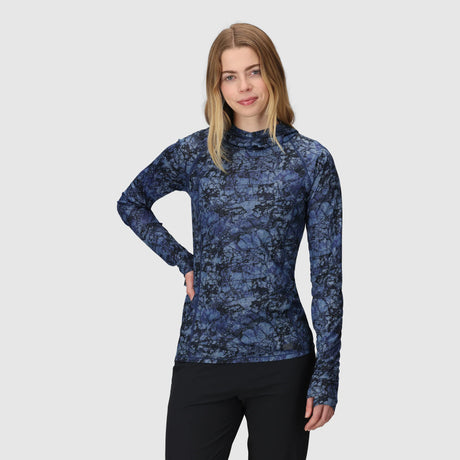Woman wearing an Outdoor Research Women's Echo Hoodie in Fjord Granite Print on a gray background