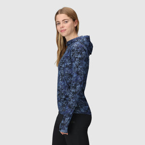 Woman wearing an Outdoor Research Women's Echo Hoodie in Fjord Granite Print on a white background