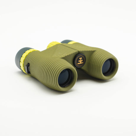 Nocs Standard Issue 10x25 Waterproof Binoculars in olive green on a neutral background.