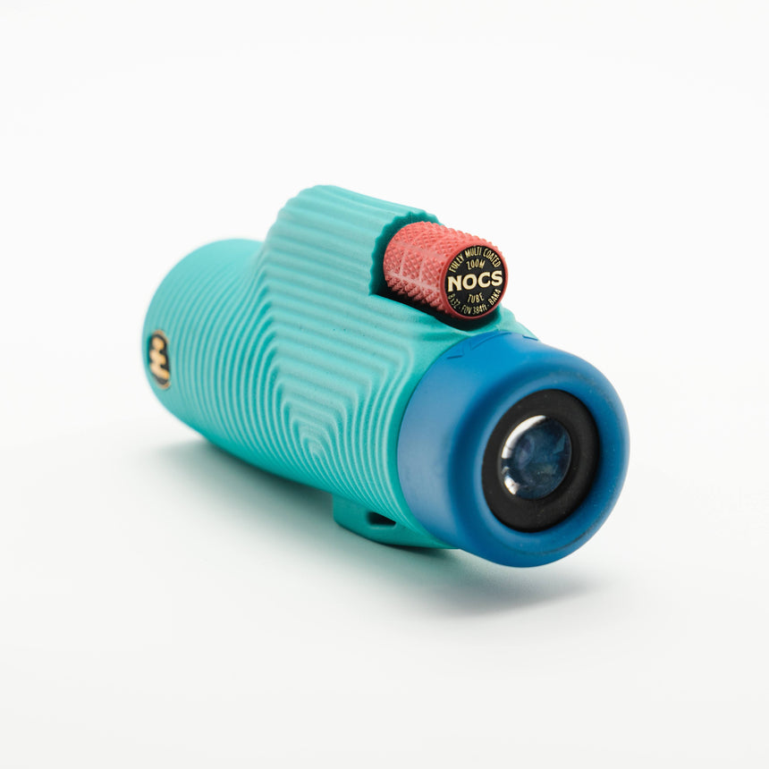 Nocs Provisions Zoom Tube 8x32 Monocular in Tahitian Blue on a neutral background at an angle.