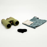 Nocs Provisions Field Issue 10X Waterproof Binoculars in Ponderosa Green on a neutral background showing the carrying pouch and strap it comes with.