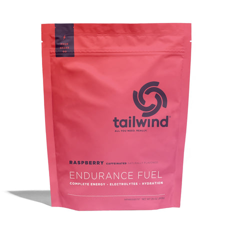 Tailwind Nutrition Endurance Fuel in Raspberry (caffeinated) on a neutral background.