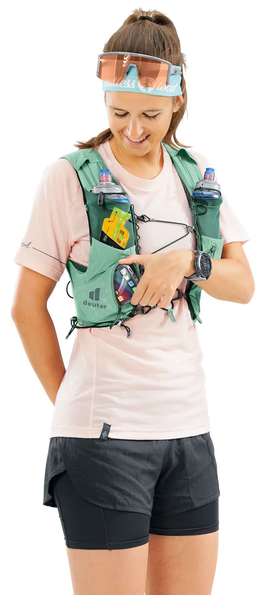 deuter Traick 5 SL running hydration vest in Spearmint-Seagreen worn by a woman on a neutral background.