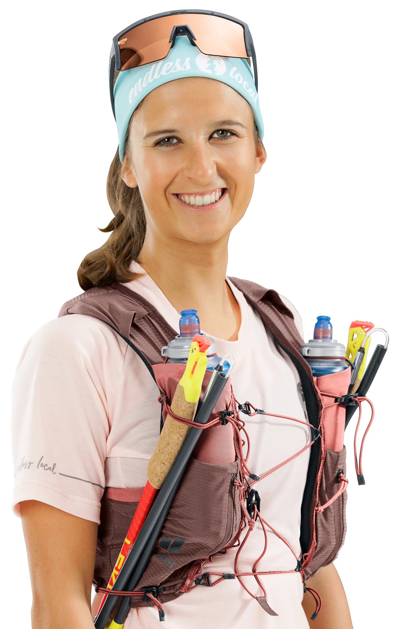 deuter Traick 5 SL running hydration vest in Raisin-Caspia worn by a woman on a neutral background.