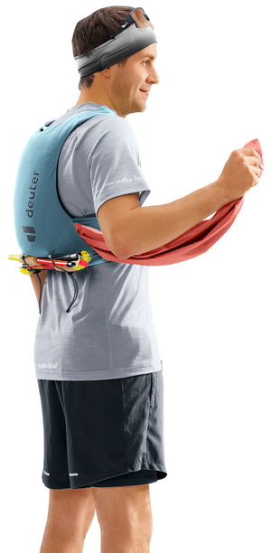 deuter Traick 9 running hydration vest in Atlantic-Ink worn by a man on a neutral background.