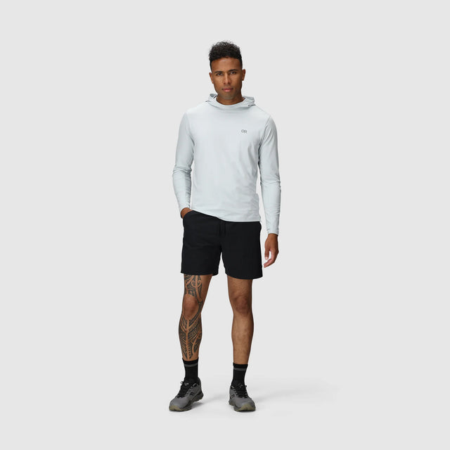 Man wearing Outdoor Research Men's Swift Lite Hybrid Shorts 7" in Black on a white background