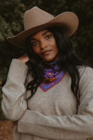 Bandits Electric Desert Parade bandana worn by a woman outdoors.