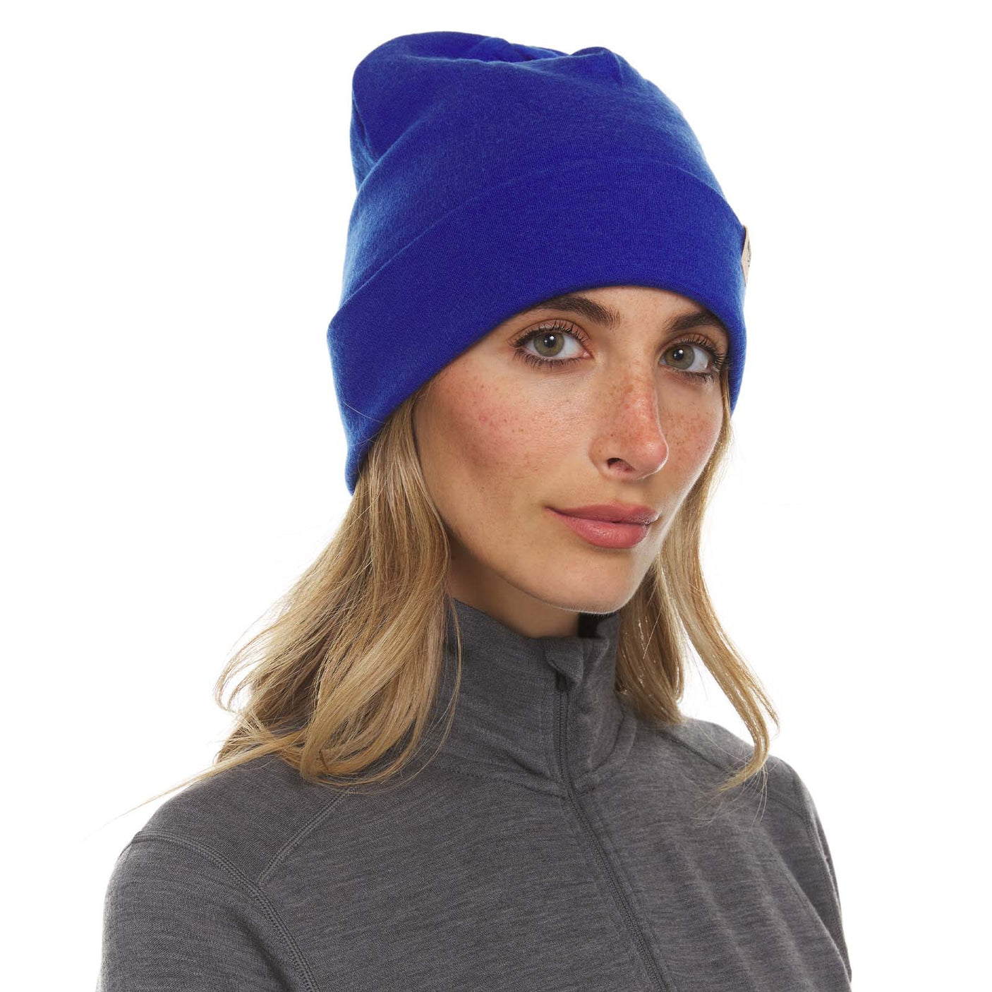 Minus33 Ridge Cuff Merino Wool Beanie in Royal Blue worn by a woman on a neutral background.