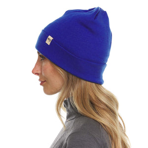 Minus33 Ridge Cuff Merino Wool Beanie in Royal Blue worn by a woman on a neutral background.