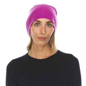 Minus33 Ridge Cuff Merino Wool Beanie in Radiant Violet being worn by a woman on a neutral background.