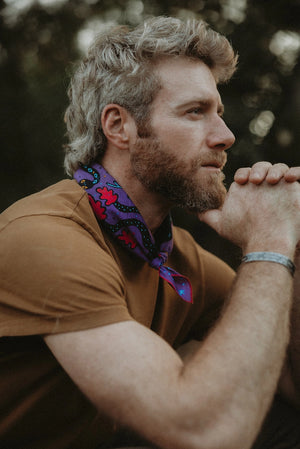 Bandits Electric Desert Parade bandana worn by a man outdoors.