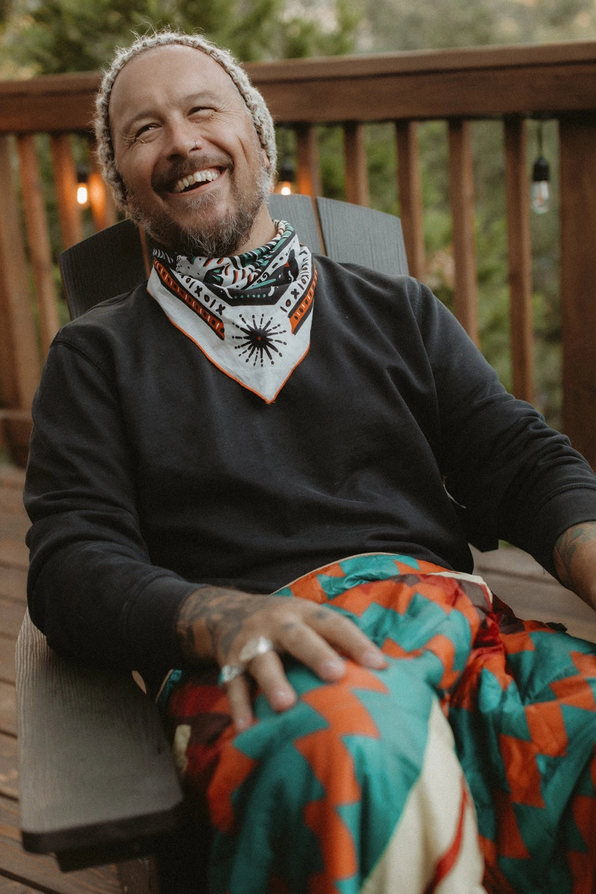 Bandits Bandana Get Lost bandana being worn by a man outdoors.