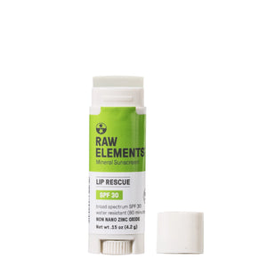 Raw Elements Lip Rescue SPF 30 lip balm on a neutral background with the top off to show the lip balm.